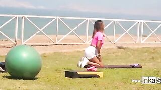A Peruvian woman is doing exercises in the gym when someone comes to her