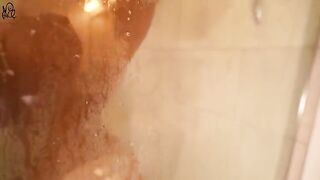 A young girl has sex with a big dildo in the shower, showcasing her tight pussy in action