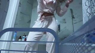 The girl caresses her pussy in the bathroom, so as not to be seen