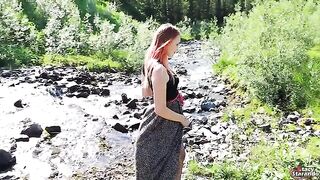 A cheerful teenage girl in red hair seduces a guy and fucks with him outdoors