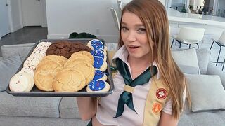 The girl is motivated to sell cookies and she will do anything to reach her goal