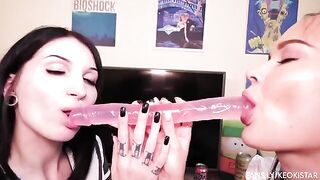 Two lesbian babes have their juicy pussies playfully fucked with a dildo