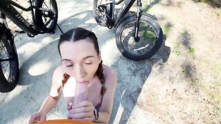 Petite cyclist tours forest with her big gun guide