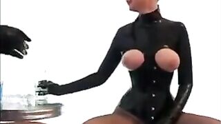 Lesbians in latex rub each other’s wet pussies