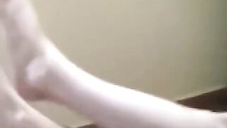 A naked girl with big natural tits is smoking in the kitchen