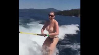 A sexy girl is water skiing without any clothes on