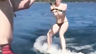 A sexy girl is water skiing without any clothes on
