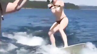 A sexy girl is water skiing without any clothes on