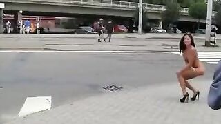 A young and sexy brunette poses her body in public for everyone to see