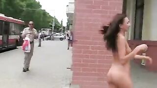 A young and sexy brunette poses her body in public for everyone to see