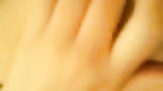 A beautiful girl plays with her juicy, wet pussy on the bed