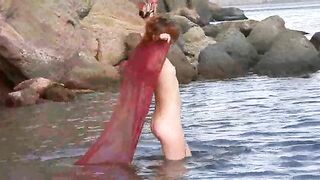 A sexy girl with small boobs gets wet in the rain