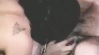 A man has sex with a girl with a strapon and another girl fingering him