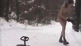 Nude girls have fun with snowballs on the street in the winter