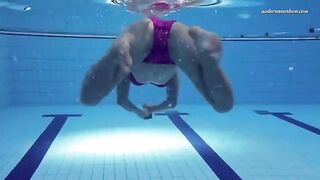 A hot and sexy woman is swimming naked in the pool