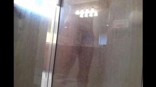 A man washes his body in the shower, not suspecting a thing