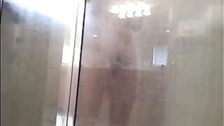 A man washes his body in the shower, not suspecting a thing