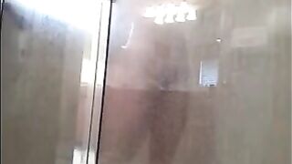 A man washes his body in the shower, not suspecting a thing