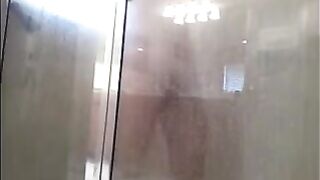 A man washes his body in the shower, not suspecting a thing