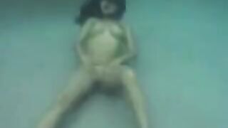 Sex in the ocean with a busty brunette, featuring underwater action