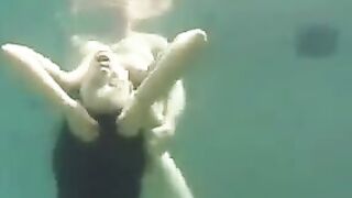 Sex in the ocean with a busty brunette, featuring underwater action