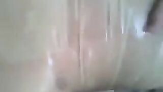 A condom is being put on the dick and jerking off his hand