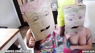 Girls put on each other's bags on their heads