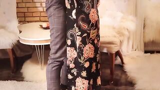 A girl in a long black dress and high heels is fucking like a slut
