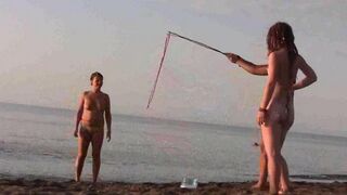 Nude beauty has fun on the beach in a hot way