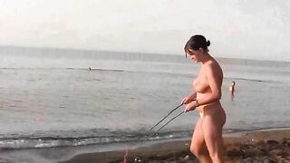 Nude beauty has fun on the beach in a hot way