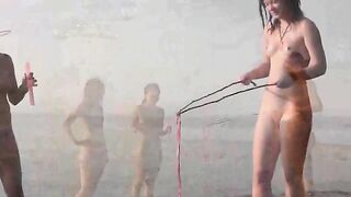 Nude beauty has fun on the beach in a hot way