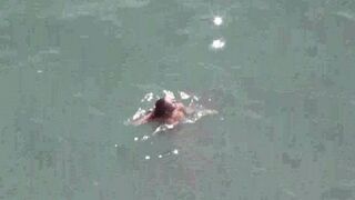 A pair of naked people at the sea