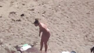 A pair of naked people at the sea