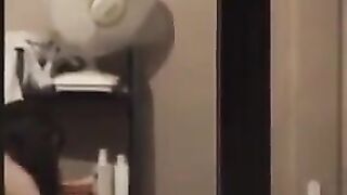 He admires himself in the mirror completely naked