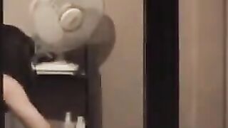He admires himself in the mirror completely naked