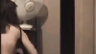 He admires himself in the mirror completely naked