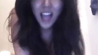 The little Asian girl plays with her pussy on the bed