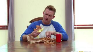 A wife fucks herself in the kitchen with a cucumber