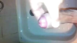 The kid caresses his dick under the shower with his hand