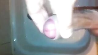 The kid caresses his dick under the shower with his hand