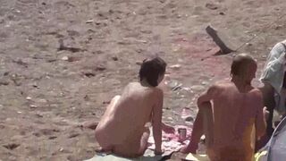 Two naked girls playing in the sea, getting wet and enjoying themselves