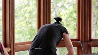 Vietnamese girl with a strap-on fucks her friend in the kitchen
