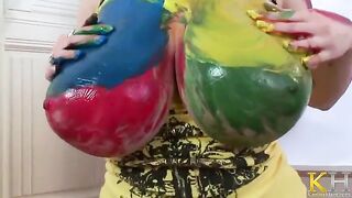 The woman is painting a picture and masturbating herself