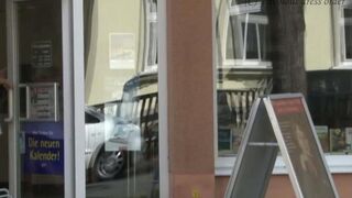 A girl walks without panties on the city streets, showing her ass