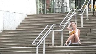 A girl walks without panties on the city streets, showing her ass