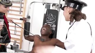 A Negro man has sex with two girls in a latex suit