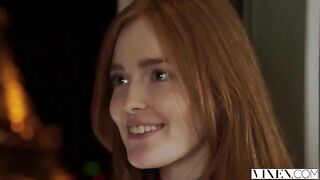 The guy carefully licks the red hair of his girlfriend