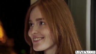 The guy carefully licks the red hair of his girlfriend