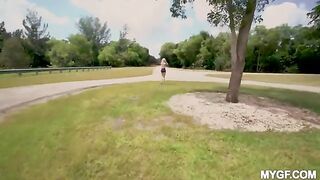 A couple is having fun outdoors in the park without any restrictions