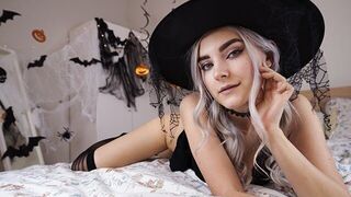 A cute witch in a pink dress waits for her magic lover